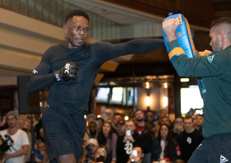 UFC middleweight champion Israel Adesanya, left, of Nigeria,