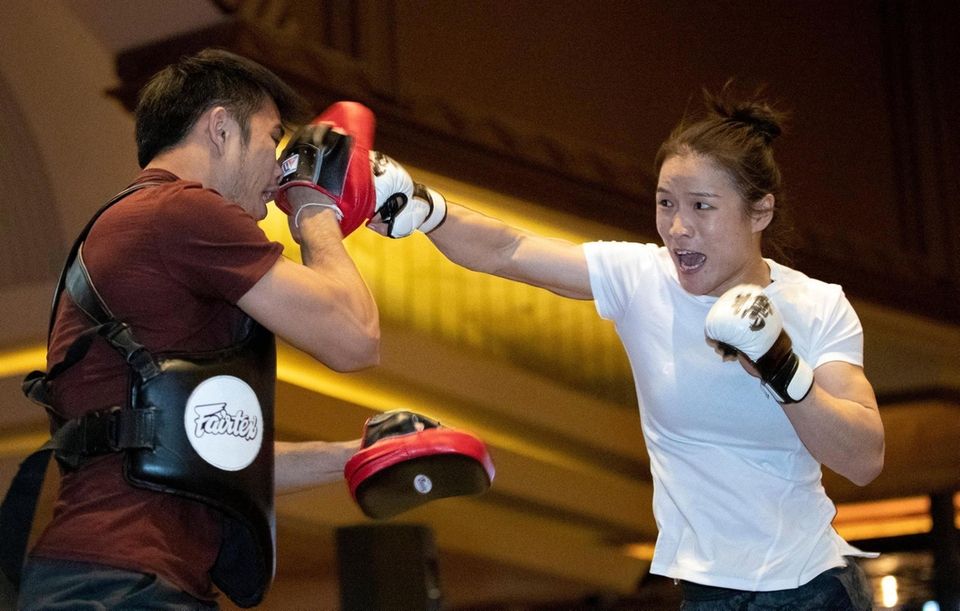 UFC women's strawweight champion Zhang Weili, right, of
