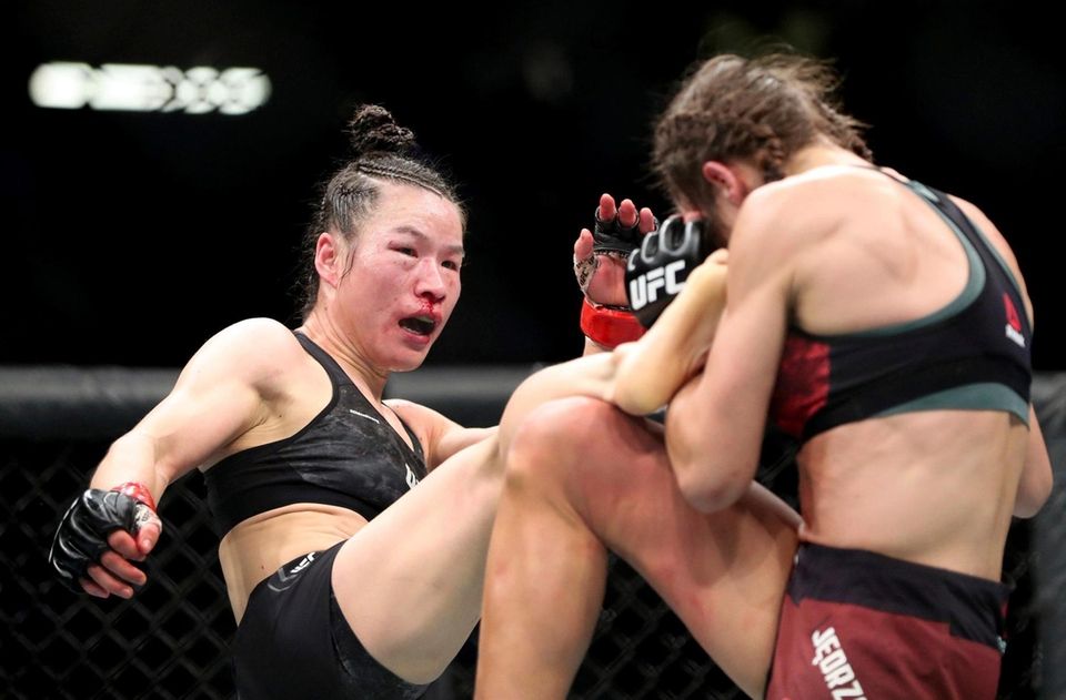 UFC women's strawweight champion Weili Zhang, left, of