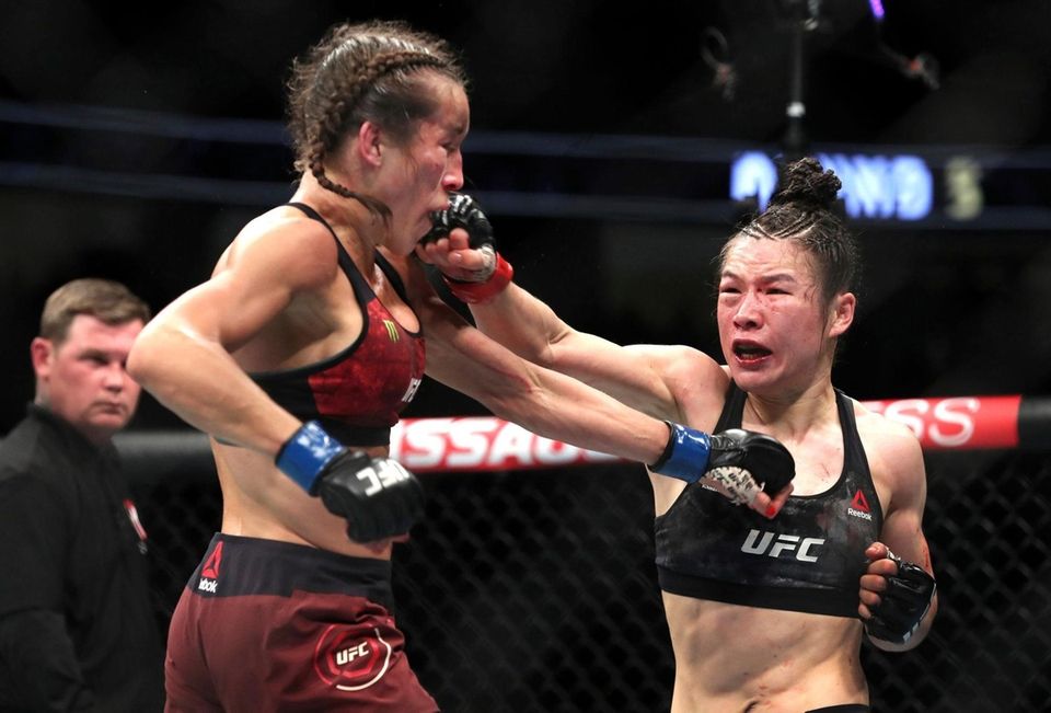 UFC women's strawweight champion Weili Zhang, right, punches