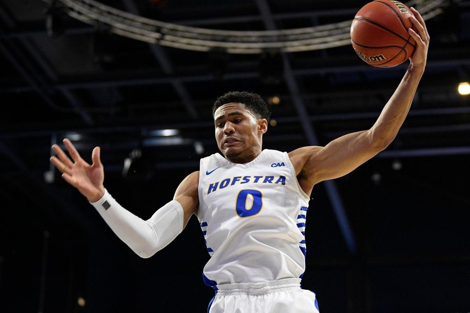 Hofstra guard Tareq Coburn grabs a rebound during