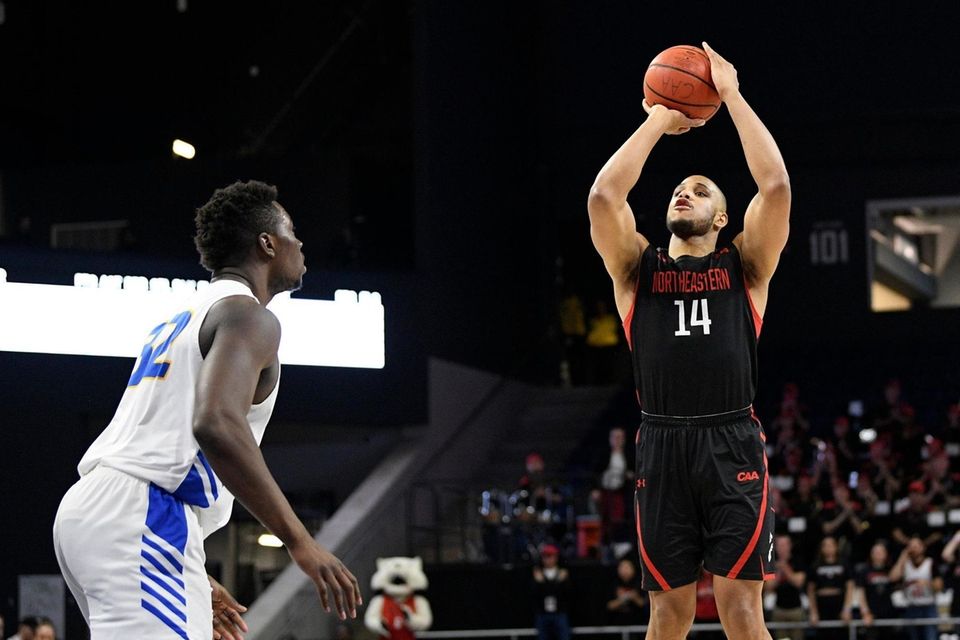 Northeastern guard Max Boursiquot (14) shoots over Hofstra