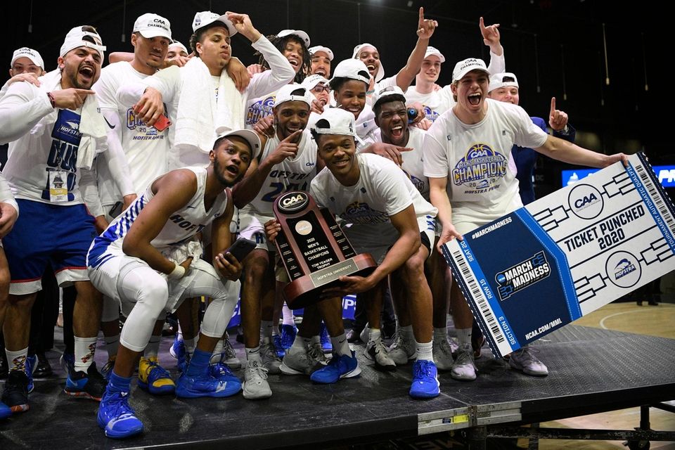 Hofstra players pose with the trophy after they