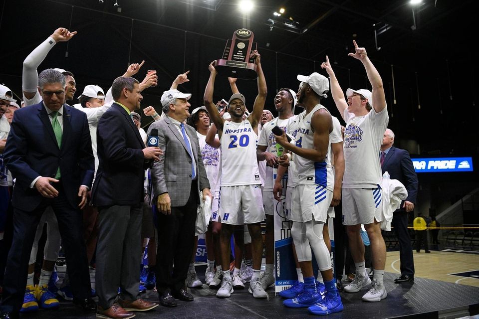 Hofstra guard Jalen Ray (20) and others raise
