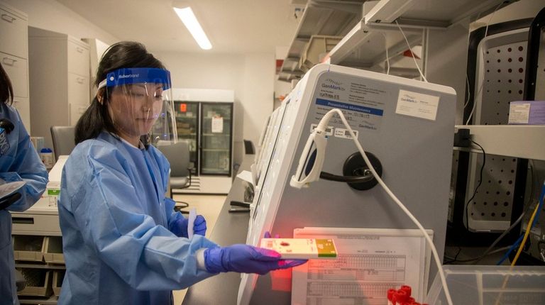 Ka Wai Chan, a medical technologist, conducts tests