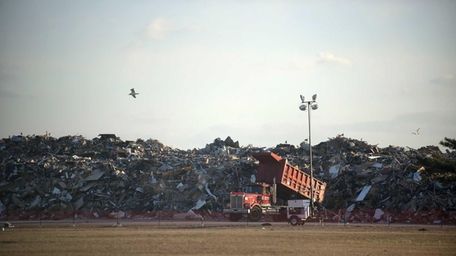 Debris from superstorm Sandy is dumped at a