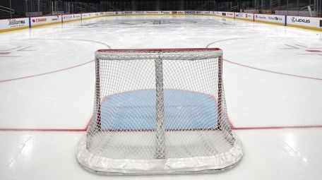 A goal sits on the empty ice prior