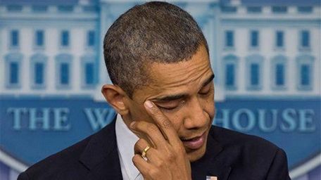 President Barack Obama wipes his eye as he