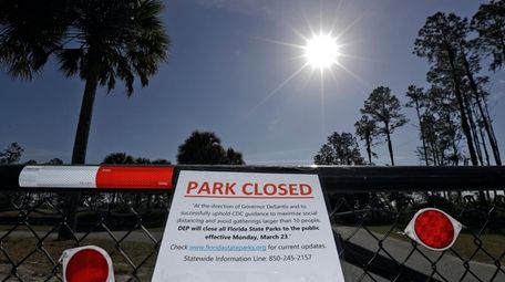 A closed sign, attached on the outside fence
