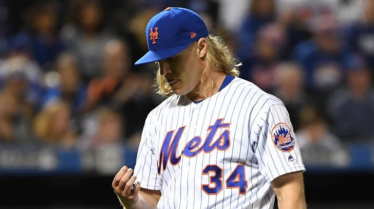 Mets pitcher Noah Syndergaard walks to the dugout