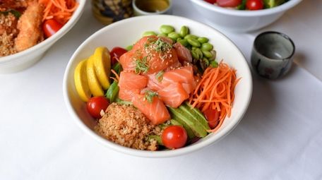 A poke bowl with a base layer of