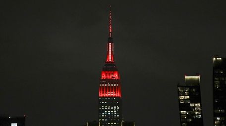 The Empire State building is lit in red