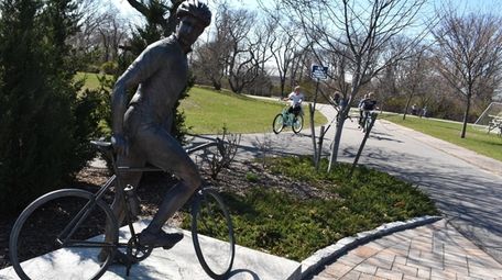A statue of a cyclist marks the path