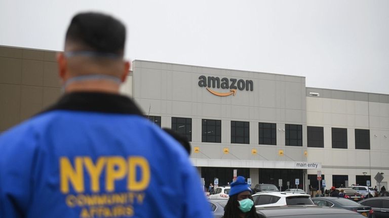 An NYPD Community Affairs officer watches as Amazon