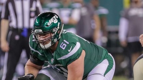 Jets offensive guard Alex Lewis lines up during