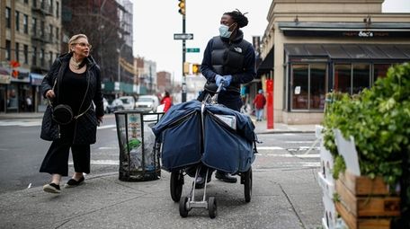 A postal worker wears a protective mask and