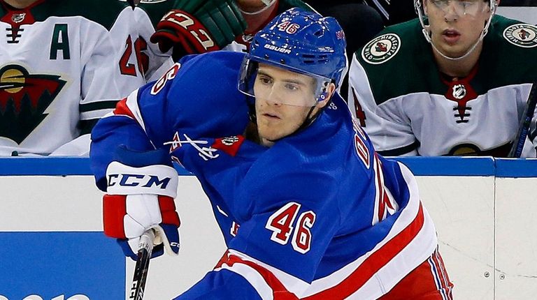 Rob O'Gara of the Rangers shoots the puck