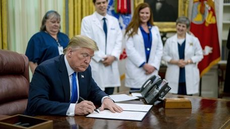 President Donald Trump signs a proclamation honoring National