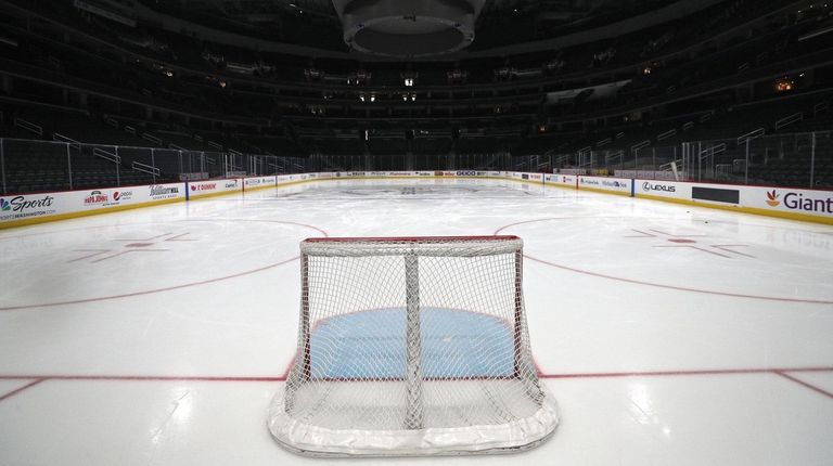 A goal sits on the empty ice prior