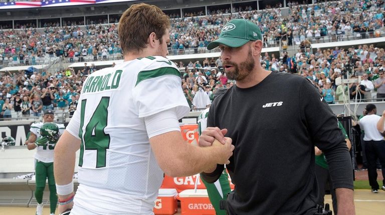 Jets head coach Adam Gase, right, talks to