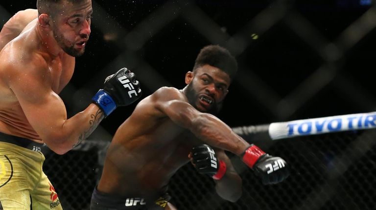 Aljamain Sterling, right, punches Pedro Munhoz at United