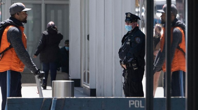 A mask-wearing NYPD officer on Tuesday in Manhattan.