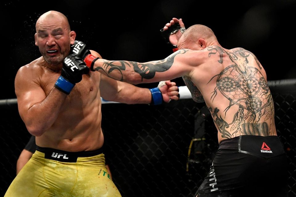 Glover Teixeira (L) of Brazil fights Anthony Smith