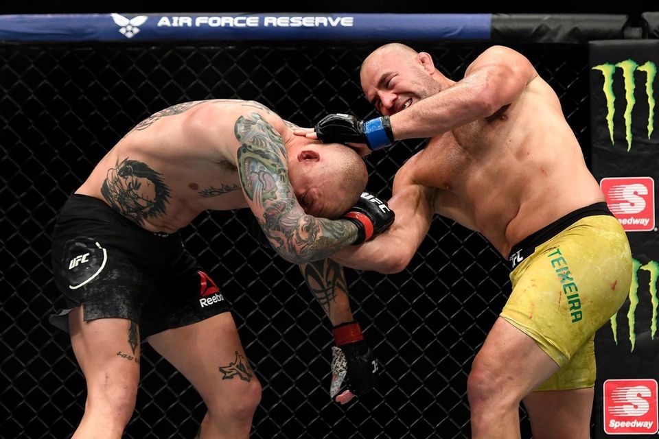 Glover Teixeira (R) of Brazil fights Anthony Smith