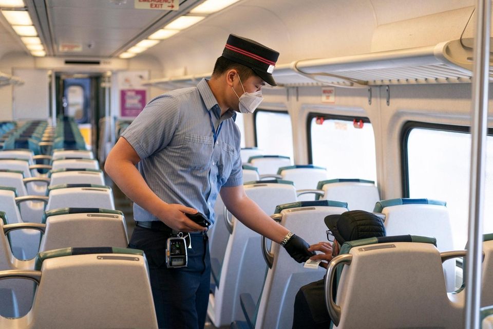 A Long Island Rail Road conductor takes a