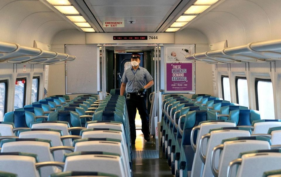 A Long Island Rail Road conductor walks in