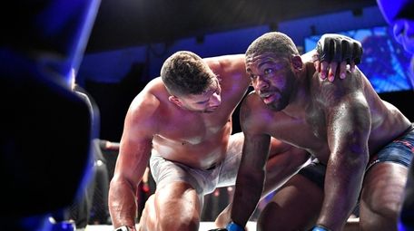 Alistair Overeem (L) of the Netherlands consoles Walt