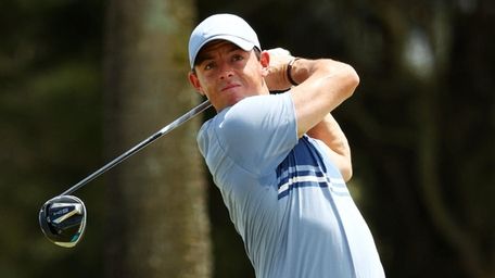 Rory McIlroy plays his shot from the fourth