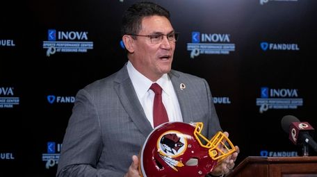 Redskins head coach Ron Rivera holds up a