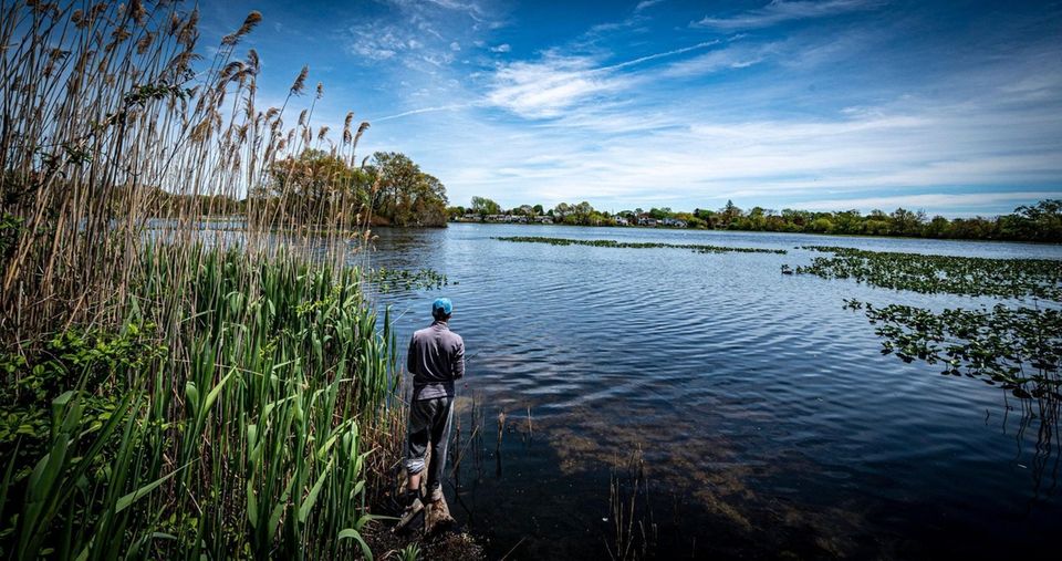 A young man fishing at Massapequa Preserve in
