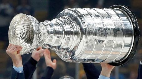 Blues coach Craig Berube carries the Stanley Cup