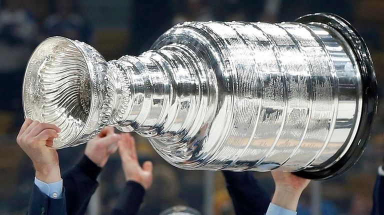 Blues coach Craig Berube carries the Stanley Cup
