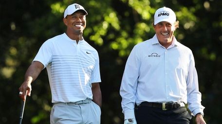 Tiger Woods, left, and Phil Mickelson share a