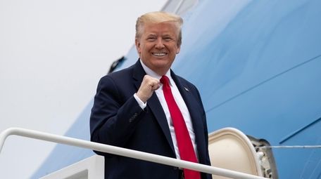 President Donald Trump boards Air Force One on