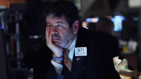 Traders work on the floor at the opening