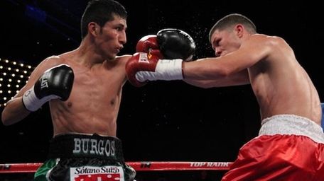 Juan Carlos Burgos (L) fights Roman Martinez in