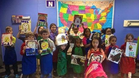 Children present their finished artwork at a workshop