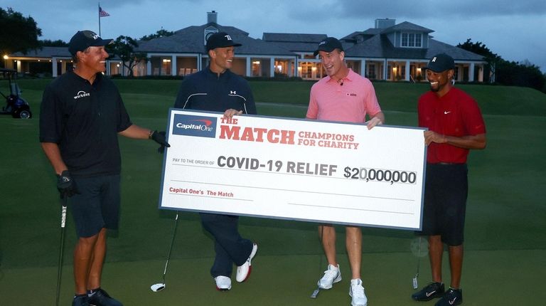 Tiger Woods and Peyton Manning celebrate on the