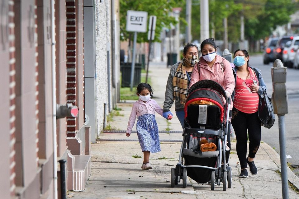 A group of people walk down Church St.