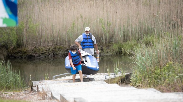 Ari Friend, 9, helps his father David carry