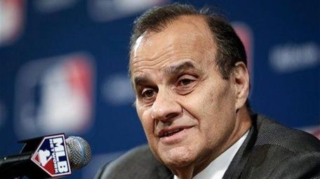 Joe Torre answers questions at the baseball winter