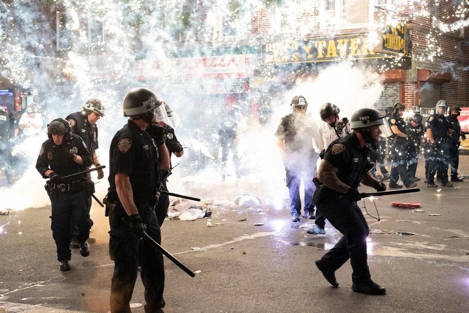 An firework lit by a protester detonates next