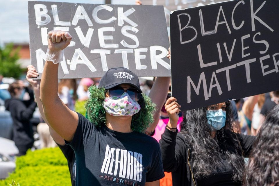 Demonstrators march on South Oyster Bay Road in