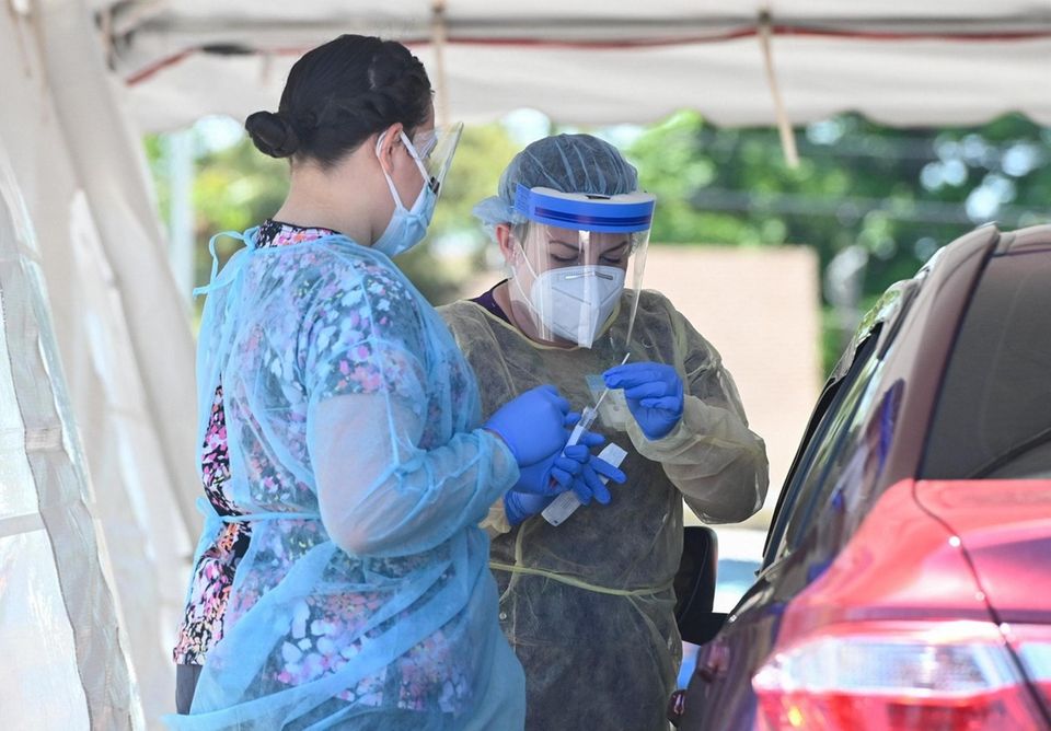 Healthcare workers conduct coronavirus testing at the Brentwood