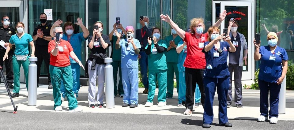 Stony Brook University healthcare staff look on during.