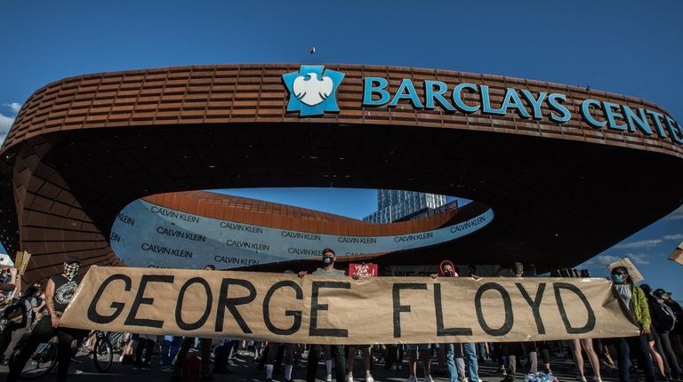 A sign reading "George Floyd," a black American